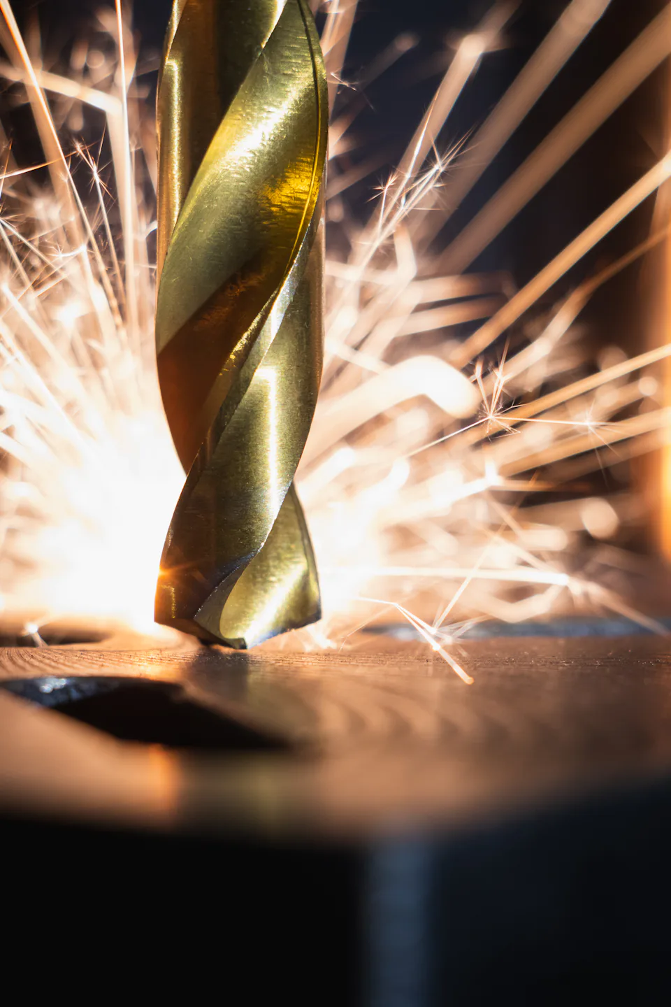 Drill bit cutting steel with sparks