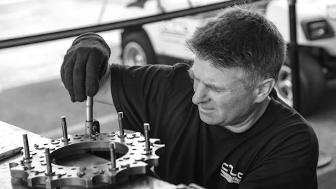 Technician servicing a mechanical assembly
