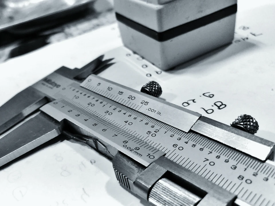 Dial caliper measuring a machined part