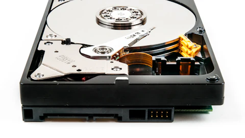 Open hard disk drive showing platter and read head
