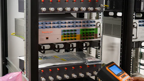 Technician testing equipment in a server rack
