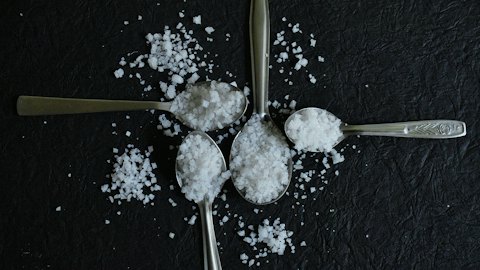 Spoons of food-grade salt crystals