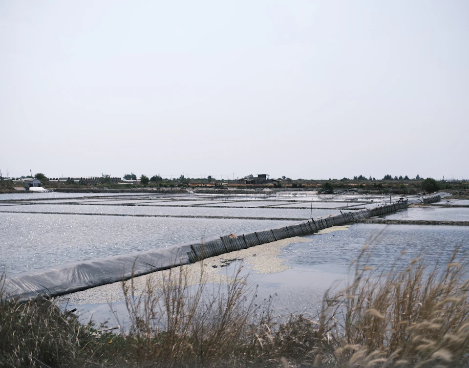 Salt evaporation pans with a wooden walkway