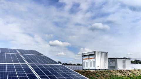 Solar array beside battery storage containers
