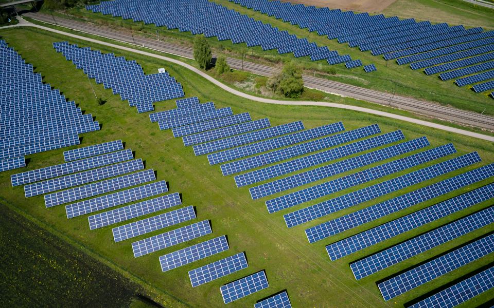 Aerial view of a solar park in green fields